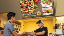 A man serving a pizza